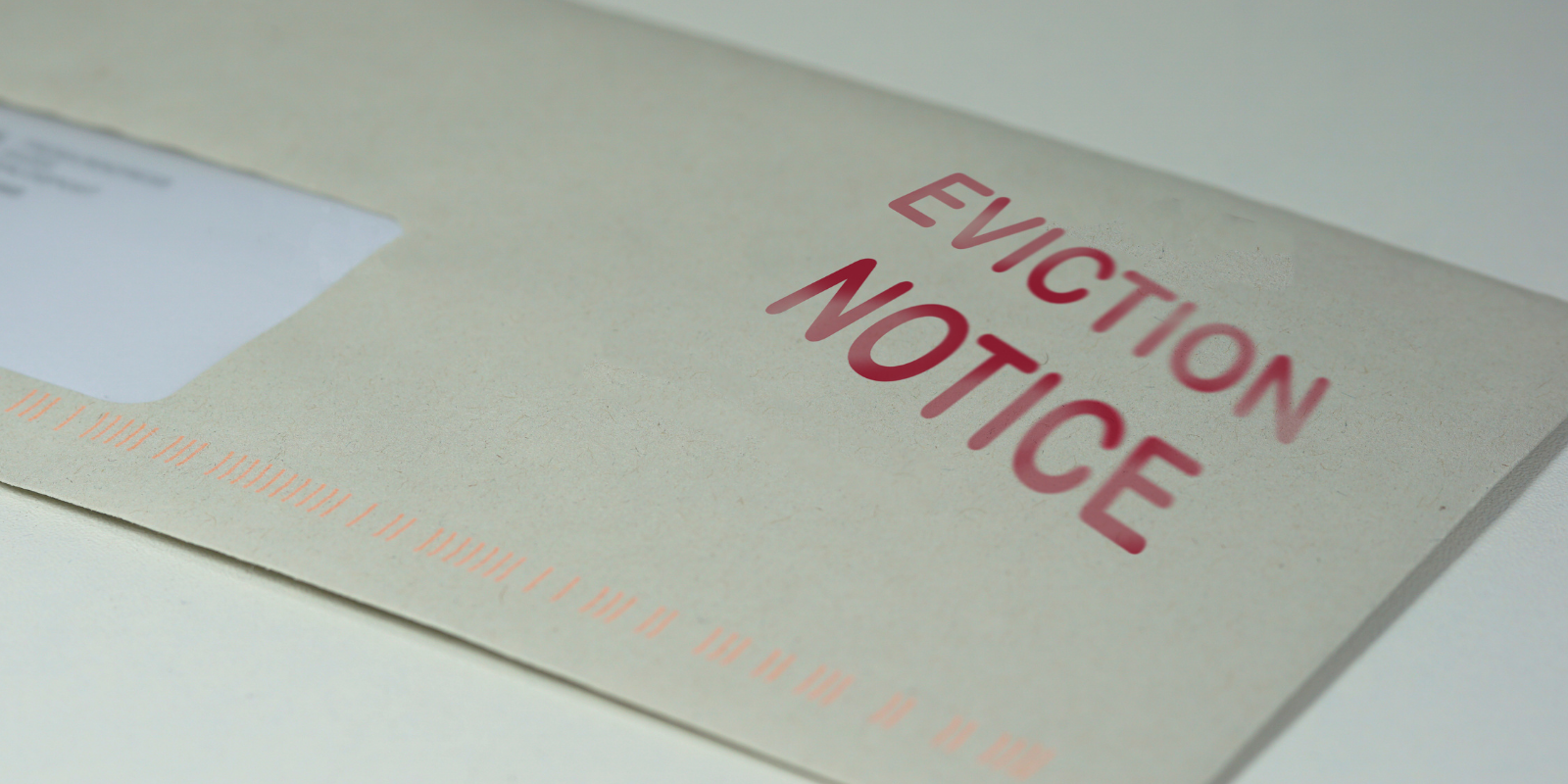 Close-up of an envelope stamped with "eviction notice" in red letters.