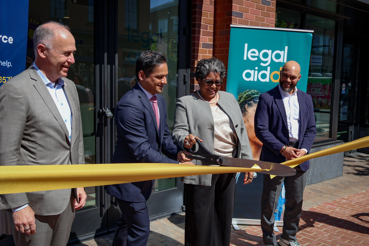 Brian Schwalb, Vikram Swaruup, Kirra Jarratt, and Robert White cut the ribbon on Legal Aid DC's new office in Anacostia.