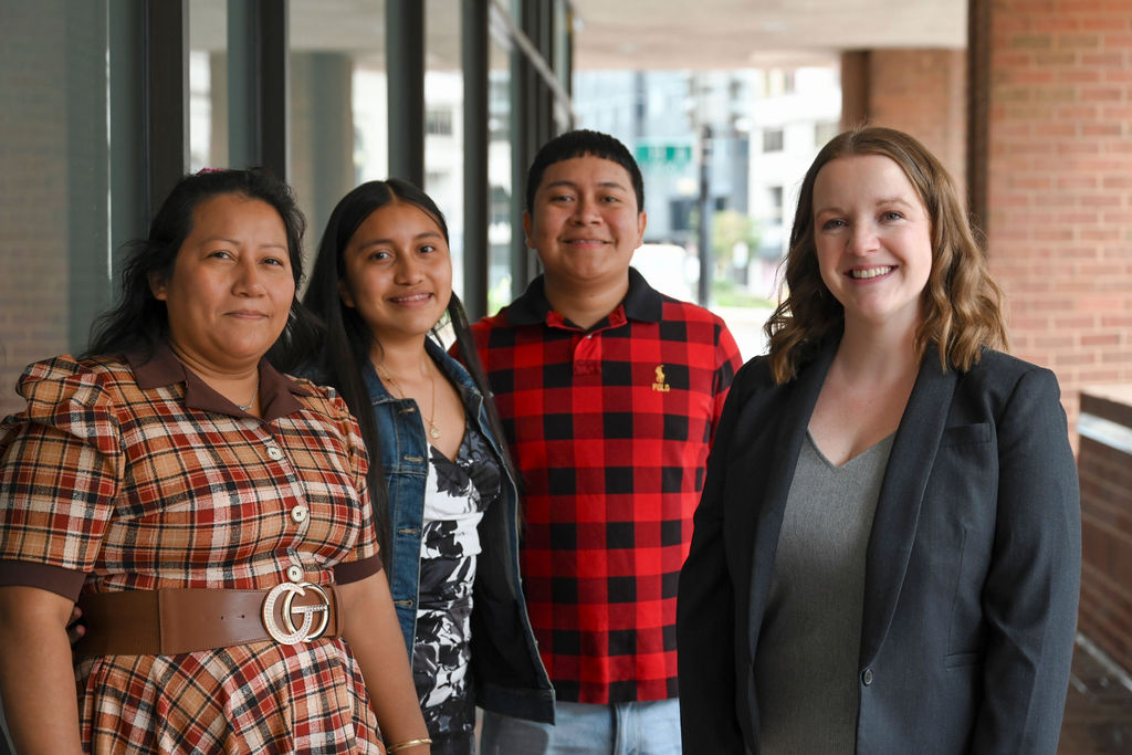 Magnolia Alvarez Velasquez with her children and Legal Aid DC attorney Julia Ward