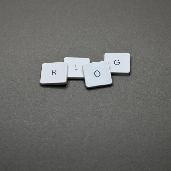 B, L, O & G keycaps of a keyword lying on a grey surface spelling out 'blog'