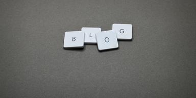 B L O & G keycaps of a keyword lying on a grey surface spelling out 'blog'