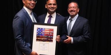 Vikram Swaruup (center) with Karl Racine (left) and Raul Fernandez (right)