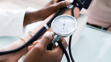 A doctor takes a patient's blood pressure